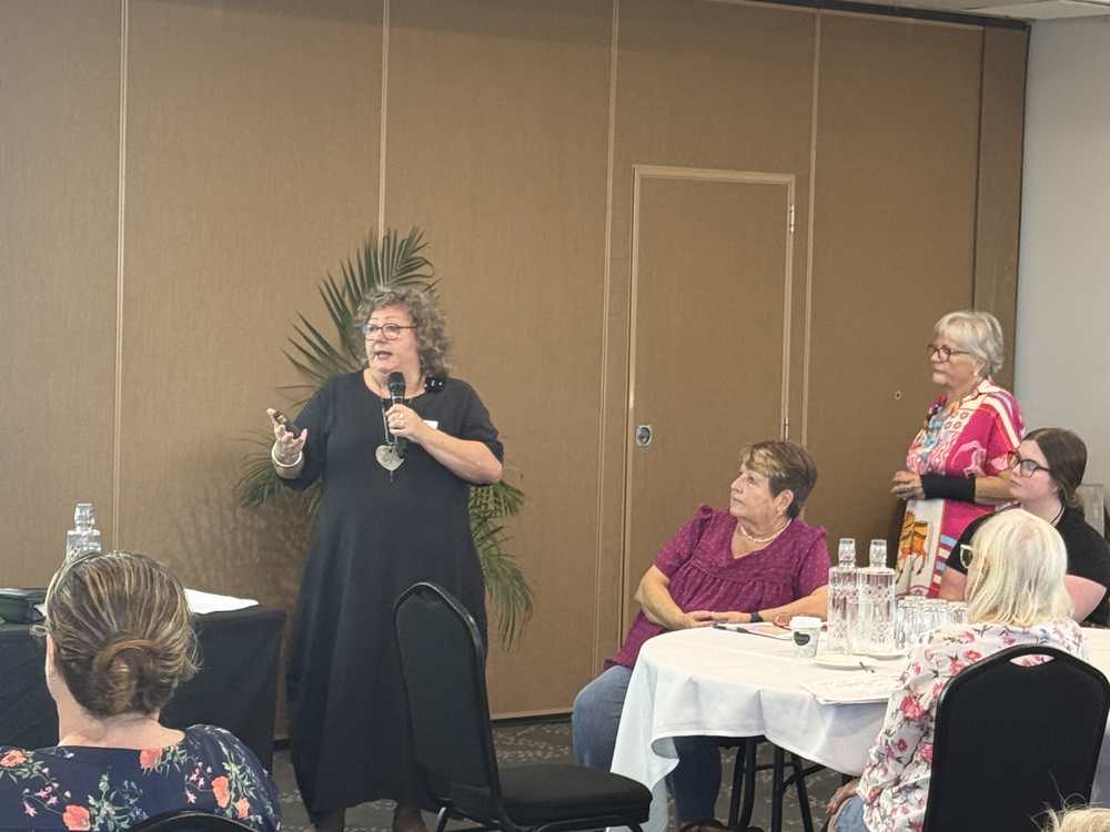 A Lifeline Mid Coast staff member speaking to the room at an information night