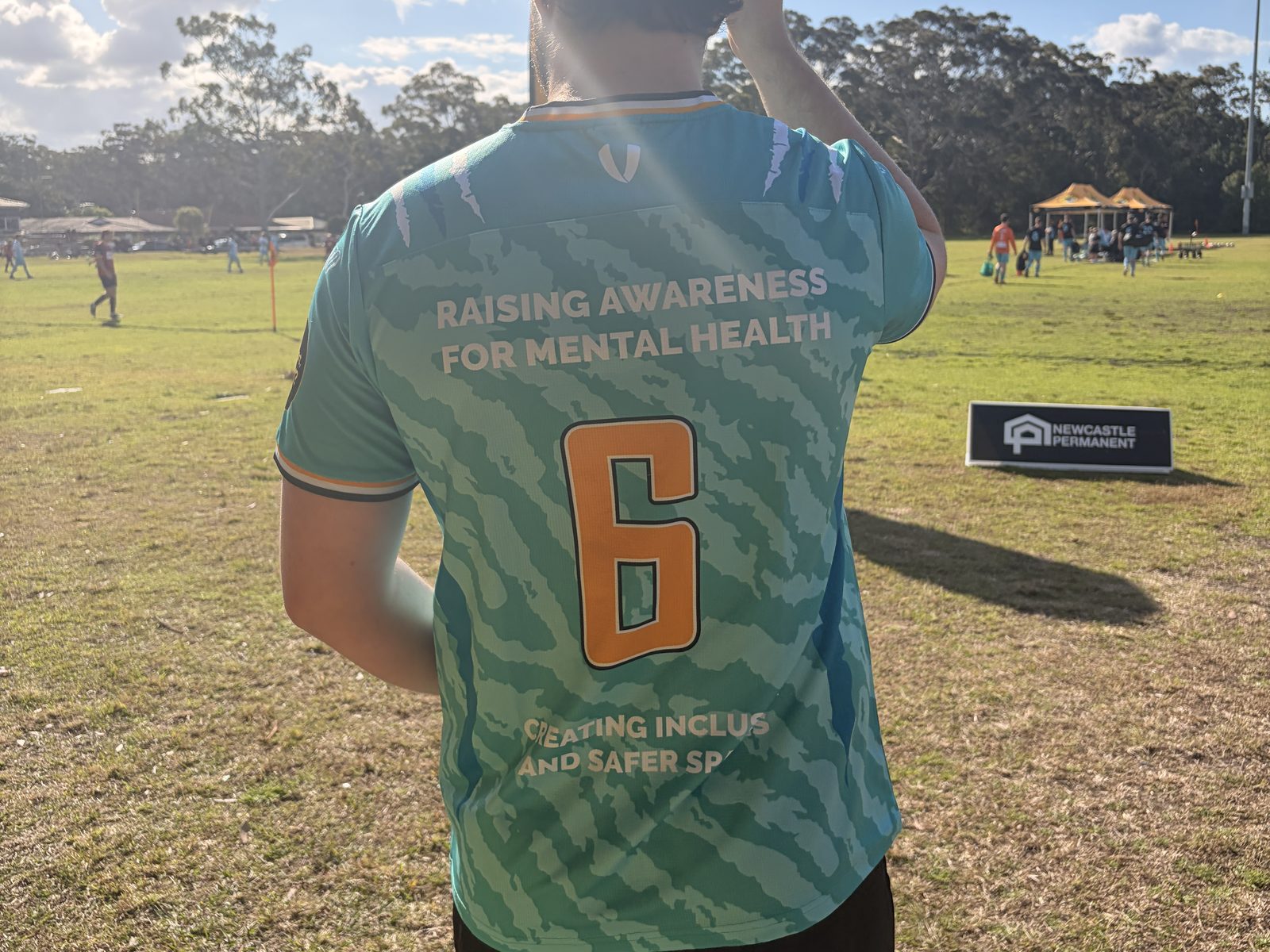 The back of a Tuncurry Forster football shirt, reading “Raising awareness for mental health”